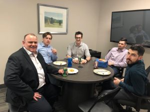 Five employees at a table