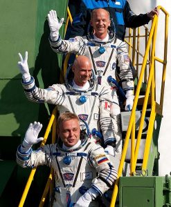 Astronauts standing on a ladder