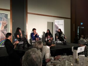 Four professional women on stage talking